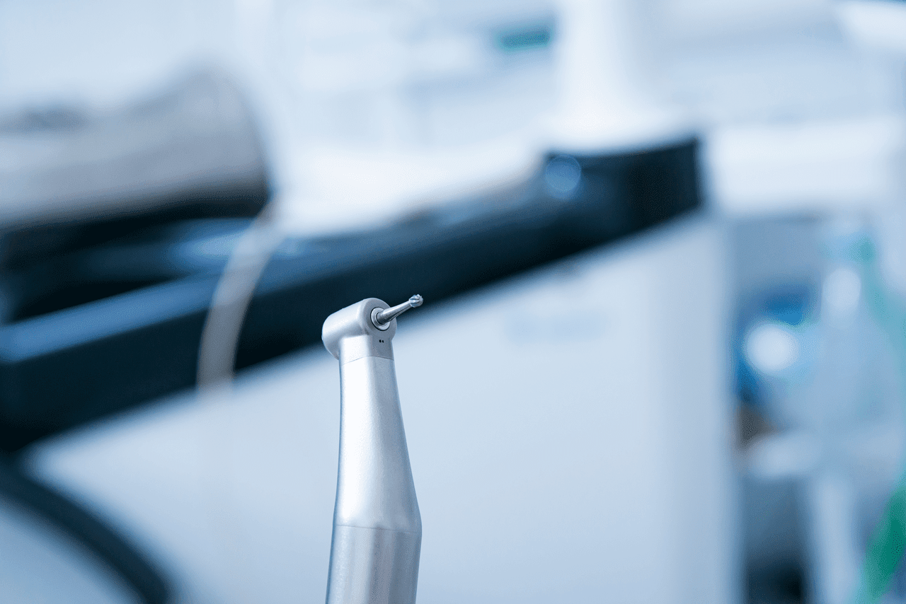 mental-health-services-2 Dentist instruments. Dental diamond cylinder bur with hand-piece. Blurred dental office background